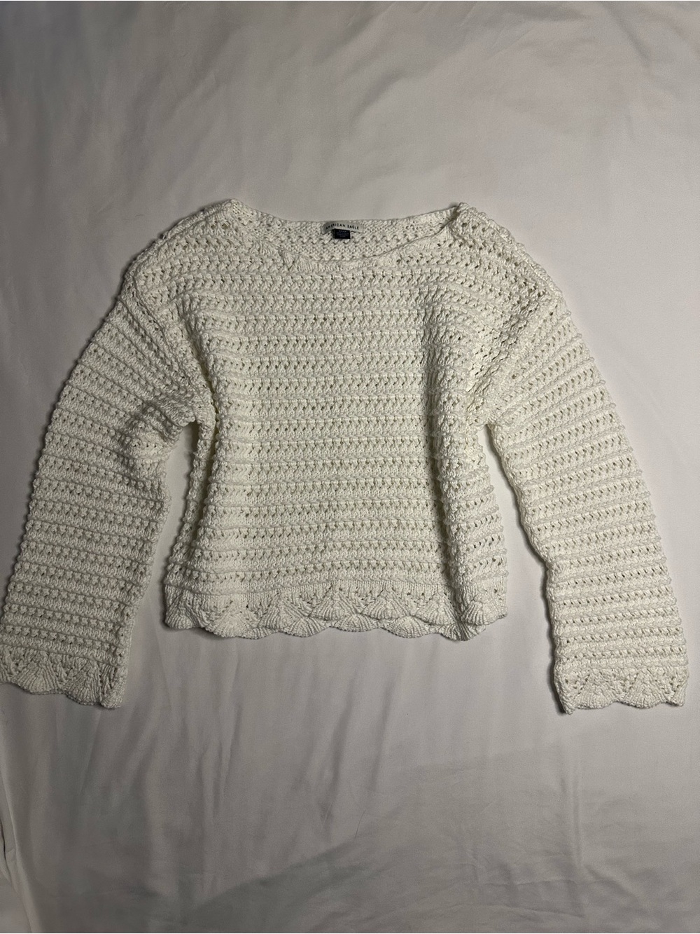 American Eagle white crochet sweater with textured knit pattern